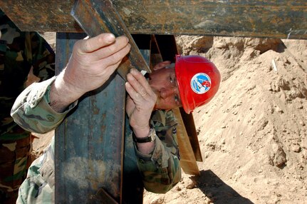 Senior Master Sgt. Larry Boyer checks to make sure this I-beam is secured safely before puts the finishing touches on a firing range that will be used by Border Patrol officers to hone in their skills May 1 near Campo, Calif. Sergeant Boyer is a member of the 201st RED HORSE Squadron from Fort Indiantown Gap, Pa.