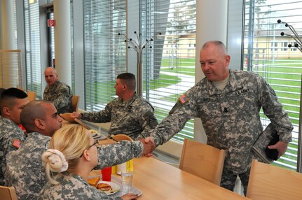 Army National Guard Command Sgt. Maj. John D. Gipe takes time to shake hands and have lunch with a group of National Guard Soldiers during his visit to the JMTC.