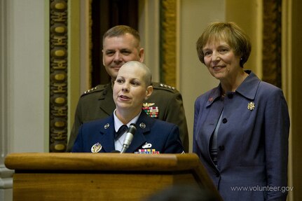 Air National Guard Master Sgt. Tammy Caban speaks after receiving the USA Freedom Corps President's Volunteer Service Award through the Military Volunteer Recognition Initiative in a ceremony at the Eisenhower Executive Office Building May 16. She was flanked by Marine Gen. James E. Cartwright, vice chairman of the Joint Chiefs of Staff, and Mary Jo Myers, President's Council on Service and Civic Participation member. Caban works in personnel at the National Guard Bureau in Arlington, Va. Caban has volunteered with the Tragedy Assistance Program for Survivors since 2004, providing grief assistance to families who have lost a loved one serving the military. She also volunteers to help patients at Walter Reed Army Medical Center.