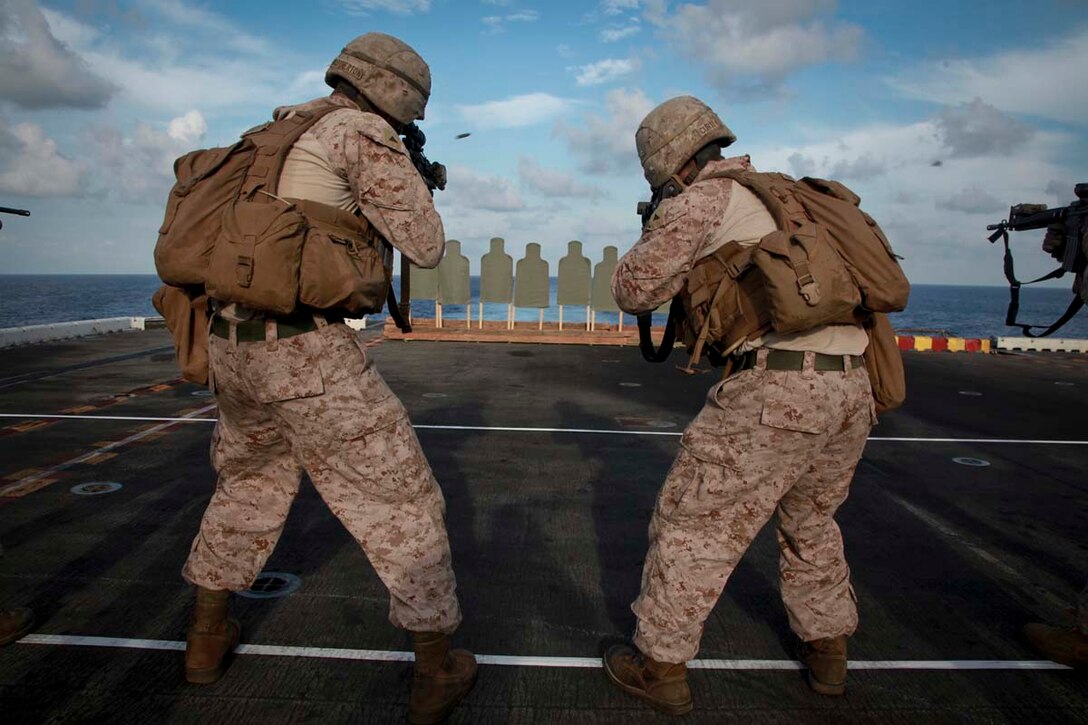 Marines with Kilo Company, Battalion Landing Team 3/5, 15th Marine Expeditionary Unit, fire at targets during a range held on the flight deck of USS Peleliu, April 6. Fifty Marines of Kilo Company, BLT 3/5, 15th MEU conducted the combat marksmanship program to keep their skills razor sharp. The 15th MEU is comprised of approximately 2,400 Marines and sailors and is deployed as part of the Peleliu Amphibious Ready Group. Together, they provide a forward-deployed, flexible sea-based Marine Air Ground Task Force capable of conducting a wide variety of operations ranging from humanitarian aid to combat. (U.S. Marine Corps photo by Cpl. John Robbart III)