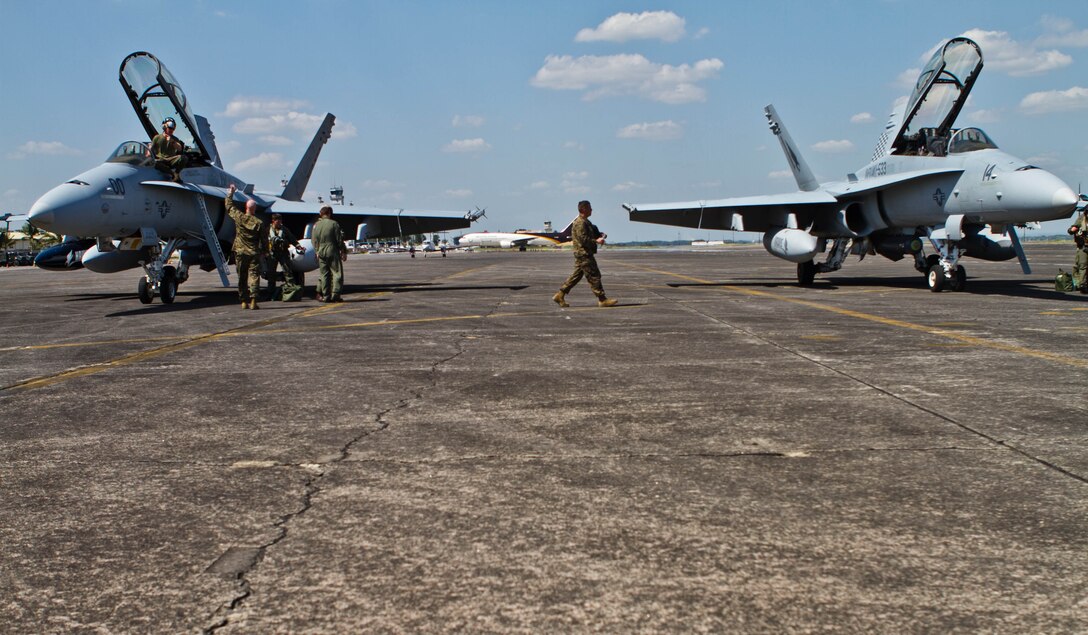 F/A-18 Hornet pilots and navigators dismount their aircraft after landing at Clark Air Base, Republic of the Philippines April 4 for the upcoming exercise Balikatan 2013. The exercise is an annual bilateral training exercise aimed at ensuring interoperability of the Philippine and U.S. militaries during planning, contingency, and humanitarian assistance operations. The exercise officially begins April 5 and is expected to conclude on April 17. The aircraft are with Marine All-Weather Fighter Attack Squadron 533, Marine Aircraft Group 31, 2nd Marine Aircraft Wing, II Marine Expeditionary Force, currently attached to Marine Aircraft Group 36, 1st MAW, III MEF under the unit deployment program.