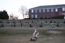Sgt. Maj. George W. Young Jr., 2nd Marine Logistics Group’s top Marine enlisted advisor, leads servicemembers in flutter kicks during a physical training session aboard Camp Lejeune, N.C., March 28, 2013. Young believes that no matter how far a person progresses, they should never be too busy to physically train with young servicemembers. (U.S. Marine Corps photo by Lance Cpl. Shawn Valosin)