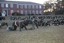 Servicemembers fight exhaustion during a weekly workout session aboard Camp Lejeune, N.C., March 28, 2013. Sgt. Maj. George W. Young Jr., 2nd Marine Logistics Group’s top Marine enlisted advisor, started the “Pain Train” to strengthen Marines and build camaraderie. (U.S. Marine Corps photo by Lance Cpl. Shawn Valosin)
