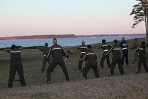 Sgt. Maj. George W. Young Jr., 2nd Marine Logistics Group’s top Marine enlisted advisor, leads servicemembers in squats during his weekly workout session behind the 2nd Marine Logistics Group Headquarters building aboard Camp Lejeune, N.C., March 28, 2013. The session consisted of circuit training as well as an endurance run across base. (U.S. Marine Corps photo by Lance Cpl. Shawn Valosin)