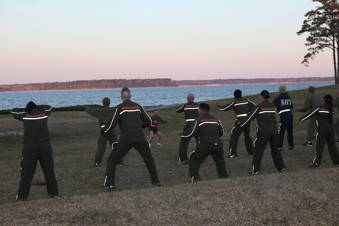 Sgt. Maj. George W. Young Jr., 2nd Marine Logistics Group’s top Marine enlisted advisor, leads servicemembers in squats during his weekly workout session behind the 2nd Marine Logistics Group Headquarters building aboard Camp Lejeune, N.C., March 28, 2013. The session consisted of circuit training as well as an endurance run across base. (U.S. Marine Corps photo by Lance Cpl. Shawn Valosin)