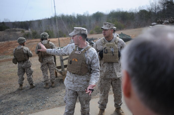 Cpl. Joshua Apsey, instructor, Warfighting group, The Basic School, and Cpl. Arif Hasan, instructor, Warfighting group, TBS, answer questions from the Military Advisory Committee while they visit Range 7 on April 4, 2013. Members were able to ask Apsey and Hasan about what they were doing in the training exercise.