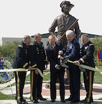 Ohio Gov. Ted Strickland (third from left) cuts the ribbon May 23 to mark the Ohio National Guard monument dedication at Beightler Armory in northwest Columbus. Assisting him are Brig. Gen. Matthew L. Kambic (from left), Ohio assistant adjutant general for Army; Maj. Gen. Gregory L. Wayt, Ohio adjutant general; Maj. Gen. Harry "A.J." Feucht, Ohio assistant adjutant general for Air; and Brig. Gen. Jack E. Lee, Ohio assistant quartermaster general.