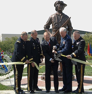 Ohio Gov. Ted Strickland (third from left) cuts the ribbon May 23 to mark the Ohio National Guard monument dedication at Beightler Armory in northwest Columbus. Assisting him are Brig. Gen. Matthew L. Kambic (from left), Ohio assistant adjutant general for Army; Maj. Gen. Gregory L. Wayt, Ohio adjutant general; Maj. Gen. Harry "A.J." Feucht, Ohio assistant adjutant general for Air; and Brig. Gen. Jack E. Lee, Ohio assistant quartermaster general.