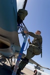 Nevada National Guard pilot Maj. Derek Routt climbs into an F-16 Viper to fly with the 64th Aggressor Squadron during the annual Red Flag Exercise at Nellis Air Force Base, Nev., in 2005.