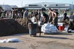 181 Intelligence Wing, Terre Haute, Ind., continuously fill sand bags in relief following the flood waters that hit early Saturday morning.