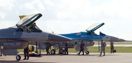 Two F-16 aircraft, one in the unit's 75th anniversary color scheme, prepare for their final flight as part of the 147th Fighter Wing.