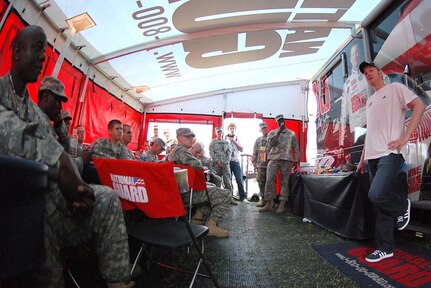 Dale Earnhardt Jr. (right) talks with Soldiers from the Pennsylvania Army National Guard June 9 at Pocono Raceway, Pa., before driving the No. 88 National Guard car in the Pocono 500. Braving near triple-digit temperatures, it was the hottest race of the season for Earnhardt and the No. 88 Guard car team, but they remained third in Sprint Cup's standings and now claim six top-five finishes and ten top-ten finishes.