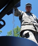 Indiana Army National Guard Spc. Daniel Dubowski dispenses water into a container for a Hope, Ind. resident, Wednesday, June 11, 2008. Dubowski, a mechanic with the 113th Engineer Battalion headquarted in Gary, Ind., deployed to southern Indiana as part of Operation Noah's Ark.
