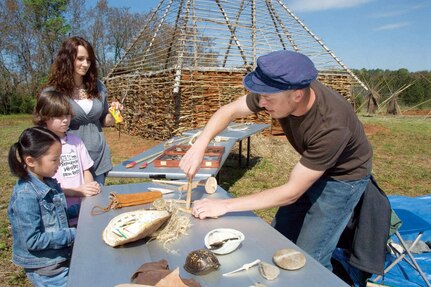 Redstone Arsenal archeologist Ben Hoksbergen demonstrates prehistoric fire-making technology to home-schooled students. He was one of the representatives from Redstone at the Pentagon Wednesday to accept the DoD Environmental Excellence award.