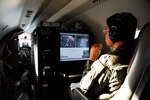 Mission system operation Lt. Col. Tim Howell of the 186th Air Refueling Wing, Meridian, Miss., operates a console aboard an RC-26. Working with several state agencies along with the Wisconsin Air National Guard, the Mississippi Air National Guard RC-26 demonstrated the benefits of this new capability during an initial flood assessment mission in southern Wisconsin on June 10. The crew flew above the flood stricken region transmitting real-time imagery to the Wisconsin Joint Operations Center and the Wisconsin Emergency Operations Center.