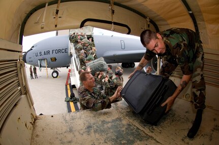 Members of the Iowa Air National Guard's 185th Air Refueling Wing unload their gear at the Eastern Iowa Airport in Cedar Rapids, Iowa. State officials activated the National Guard to the help with recovery efforts after massive flooding caused evacuations from towns along major rivers.