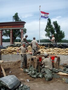 Soldiers from the 1138th Transportation Company based at Jefferson Barracks, Mo., fill sandbags on Sunday in Clarksville, Mo., an area expected to get more floodwater this week.