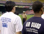 Lt. Gen. Ronald S. Coleman, deputy commandant of Manpower and Reserve Affairs at Marine Headquarters in Quantico, Va., conducts the oath of enlistment ceremony to 22 recruits from the Army and Air National Guard and other service branches during Military Appreciation Night hosted by the DC United professional soccer team on June 14 in Washington D.C.