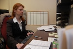 Wyoming Army National Guard Staff Sgt. Jessica Williams, works at her desk at the Cheyenne Police Department in her role as a National Guard Counterdrug Program intelligence analyst, specializing in gang activity, on June 16, 2008.