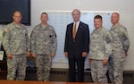 Secretary of the Army Pete Geren takes a photo with recruiters of the Minnesota National Guard Recruiting Station in Roseville, Minn., June 16.