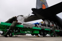 Chief Master Sgt Andy Huneycutt directs C-130 Hercules loadmasters from the North Carolina Air National Guard's 145th Airlift Wing as they load a modular airborne fire fighting system (MAFFS) June 23 at Charlotte, N.C. The guardmembers are fighting wildfires in Northern California.