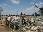 Soldiers from the Missouri National Guard's 1138th Transportation Company reinforce the main wall along the Mississippi River in downtown Clarksville.