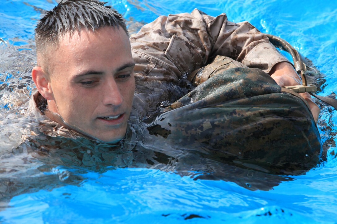 Sgt. Michael Heath, with 9th Communication Battalion, I Marine Expeditionary Force, swims across the 43 Area Training Tank during swim qualification at Camp Pendleton, Calif., April 4. Marines are tested annually on their ability and confidence to survive in water. Heath, 27, is from Beaufort, S.C.