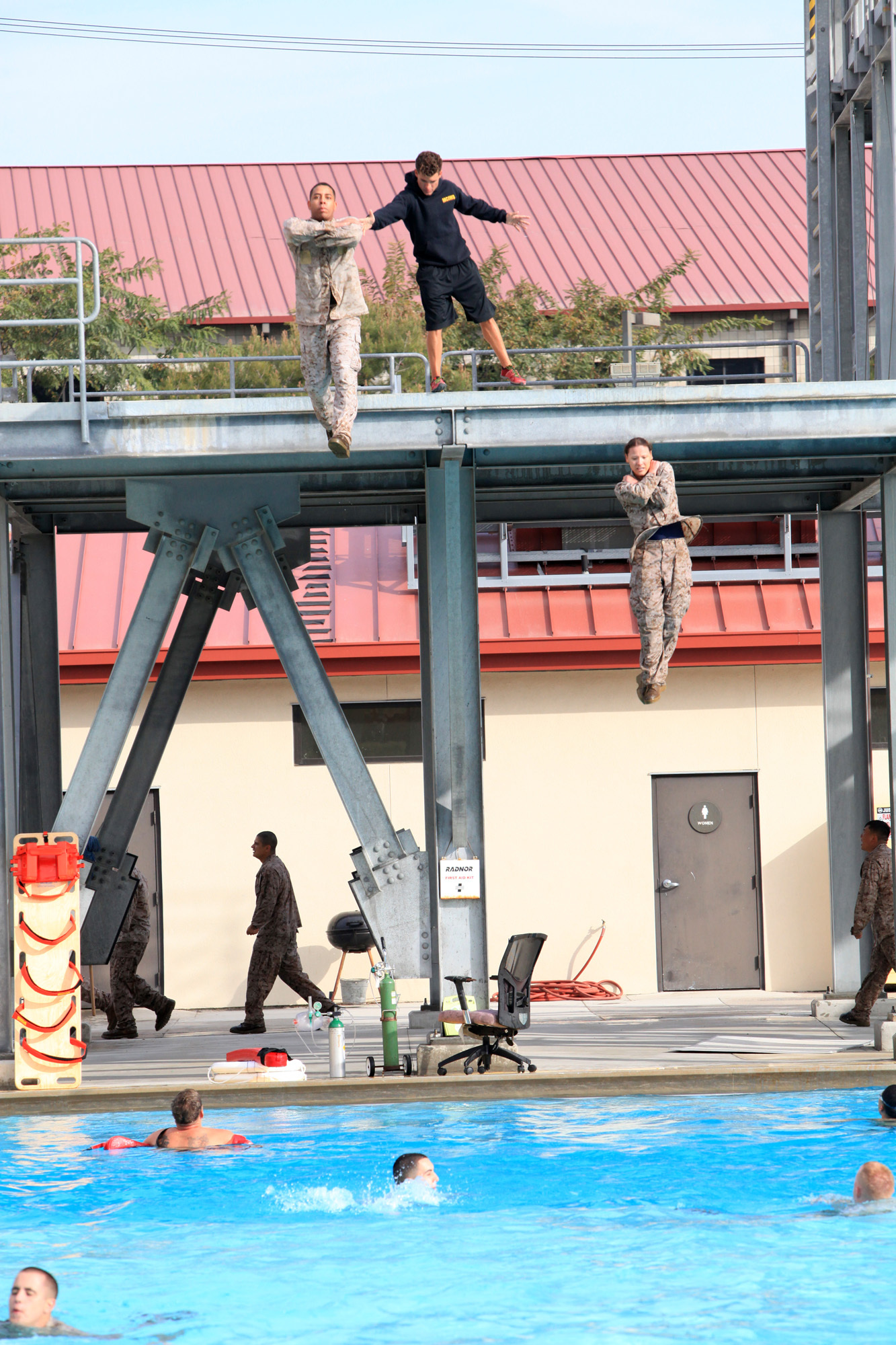 Marines with 9th Communication Battalion, I Marine Expeditionary Force, jump off a diving board during swim qualification at Camp Pendleton, Calif., April 4. Marines are tested annually on their ability and confidence to survive in water. 