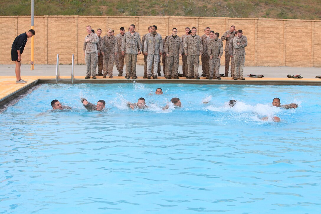 Marines with 9th Communication Battalion, I Marine Expeditionary Force swim across the 43 Area Training Tank during swim qualification at Camp Pendleton, Calif., April 4. The Marines are first tested on their ability to swim 25 meters before moving on to the other challenges. 
