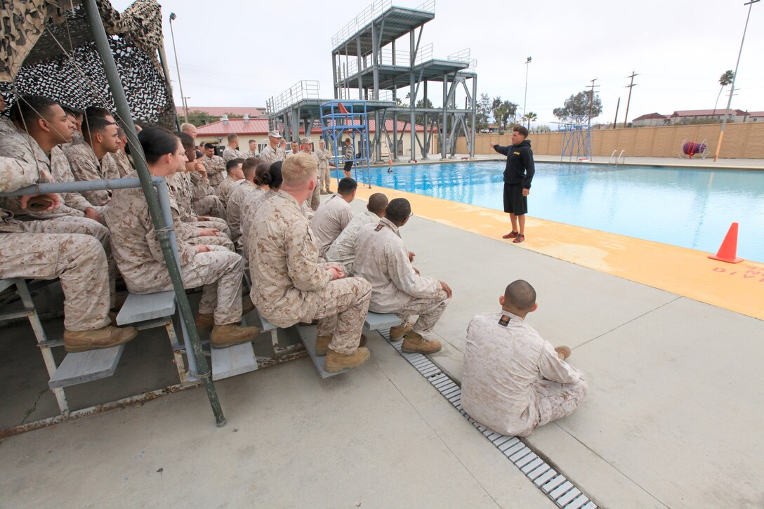Sgt. Nathan Scheeller, a Marine Corps instructor of water survival with the 43 Area Training Tank, briefs Marines before swim qualification at Camp Pendleton, Calif., April 4. The Marines test their abilities to survive in water with a full combat load. Scheeller, 28, is from Corvallis, Ore.