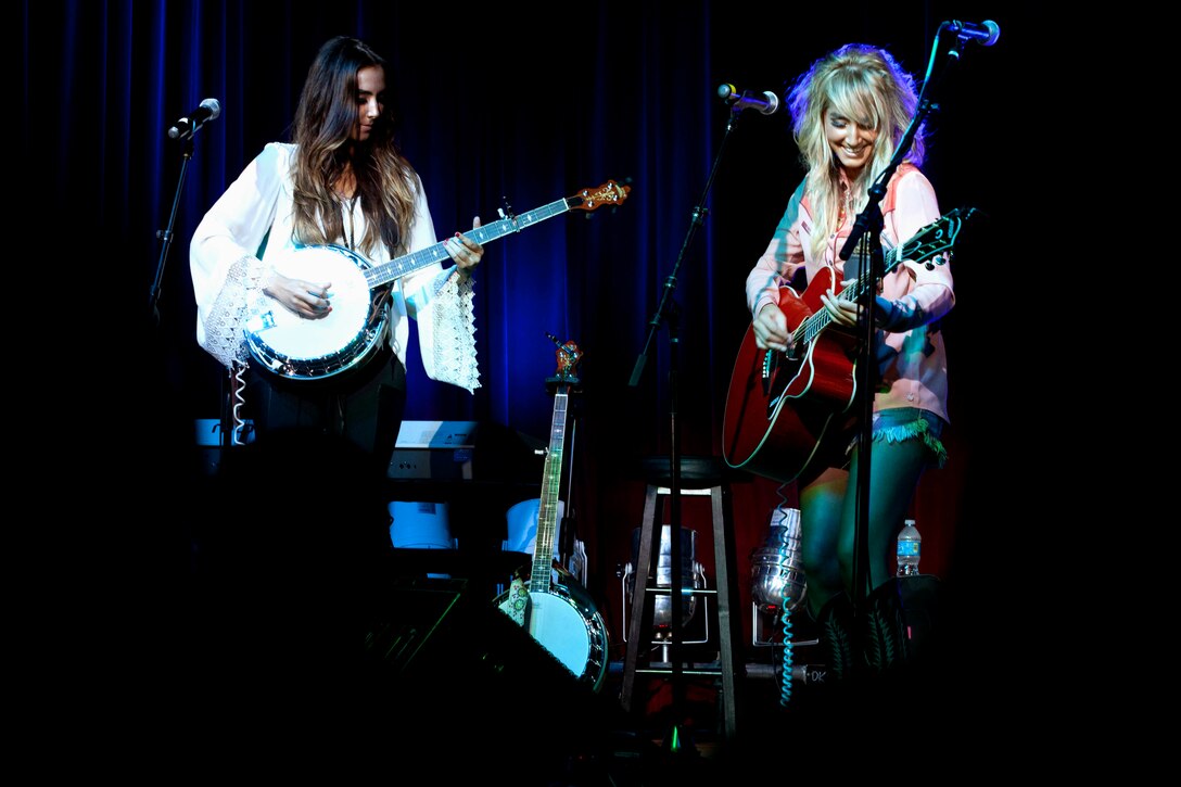 Samantha Setian, left, and Nikki Setian open for Gloriana during Stan Lee’s POW!er Concerts at the Pacific Views Event Center here April 5. The 20-year-old Setian twins started their band, Nik & Sam, in their hometown of Dover, Ark. The concert series' mission is to honor and pay tribute to the courageous everyday superheroes of the Armed Forces by bringing live entertainment with a superhero theme to the home front.