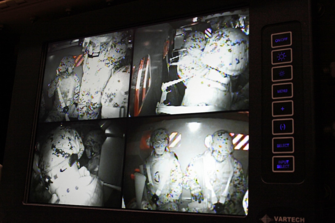 Marines from Marine Wing Support Squadron 171 prepare to simulate a roll over inside a Mine Resistant Ambush Protected Egress Trainer in building 268 here, Feb. 20, 2013. The MRAP Egress Trainer in designed to simulate a Cat II Cougar 6X6 rolling over, whether by an improvised explosive device or by accident. The MET is equipped with four cameras to monitor the inside of the simulator and has 4 emergency stop buttons in case of an emergency.