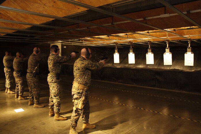 Marines choose which cards they intend to shoot for their poker hand at the Top-Shot Shootout pistol-poker tournament held at the Indoor Small Arms Range here, Feb. 22, 2013. Participants had to shoot at targets that were pasted with a full deck of playing cards in a random order.