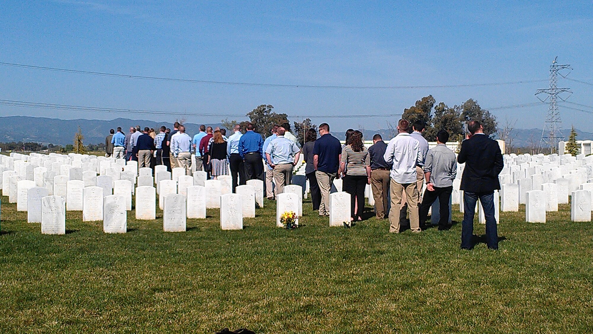 Friends and family od Capt. Dee Imlay stand solemly in the Sacramento Valley National Cemetary April 6, 2013. Imlay died March 28, 2012, in an accident involving an F-15E Strike Eagle near a base in Southwest Asia and many members of the squadron were not able to attend his funeral at the time. (Courtesy photo)