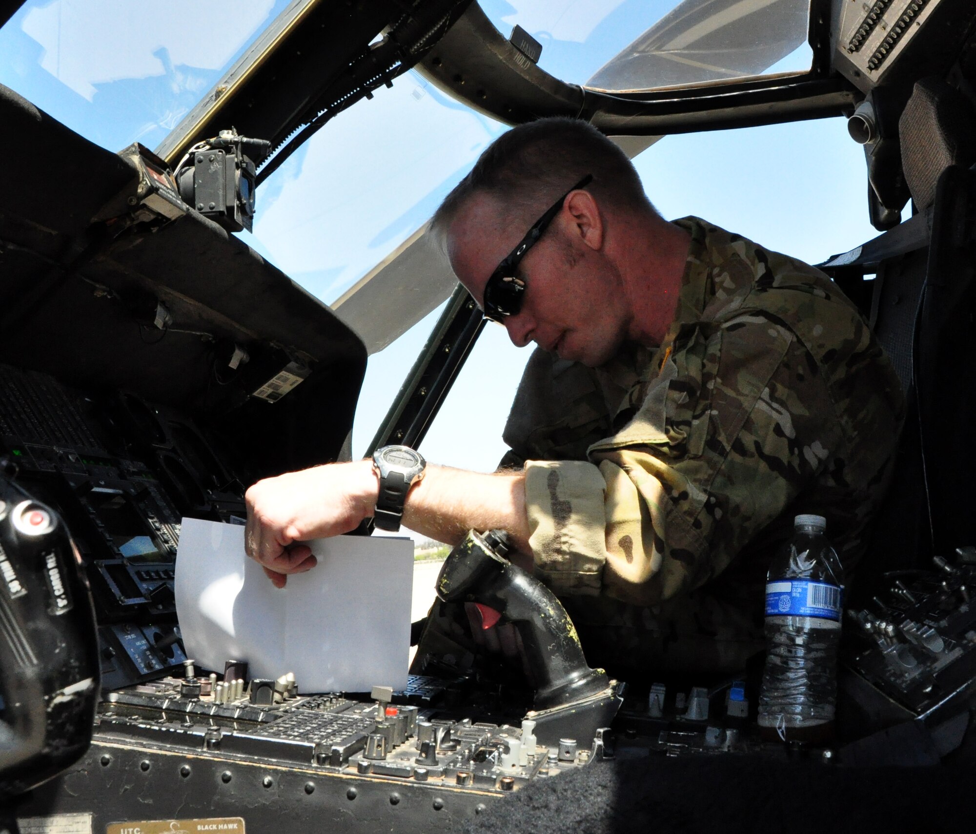 Tech Sgt. Sean Loose, from the 305th Rescue Squadron, review flight plans prior to a routine training mission at Davis-Monthan Air Force Base, Tucson Ariz. during the 943rd Rescue Group’s April Unit Training Assembly weekend. The training flights ensure the safety and readiness of the HH-60G Pave Hawk helicopter crews. (U.S. Air Force Photo/Staff Sgt. Sarah Pullen)