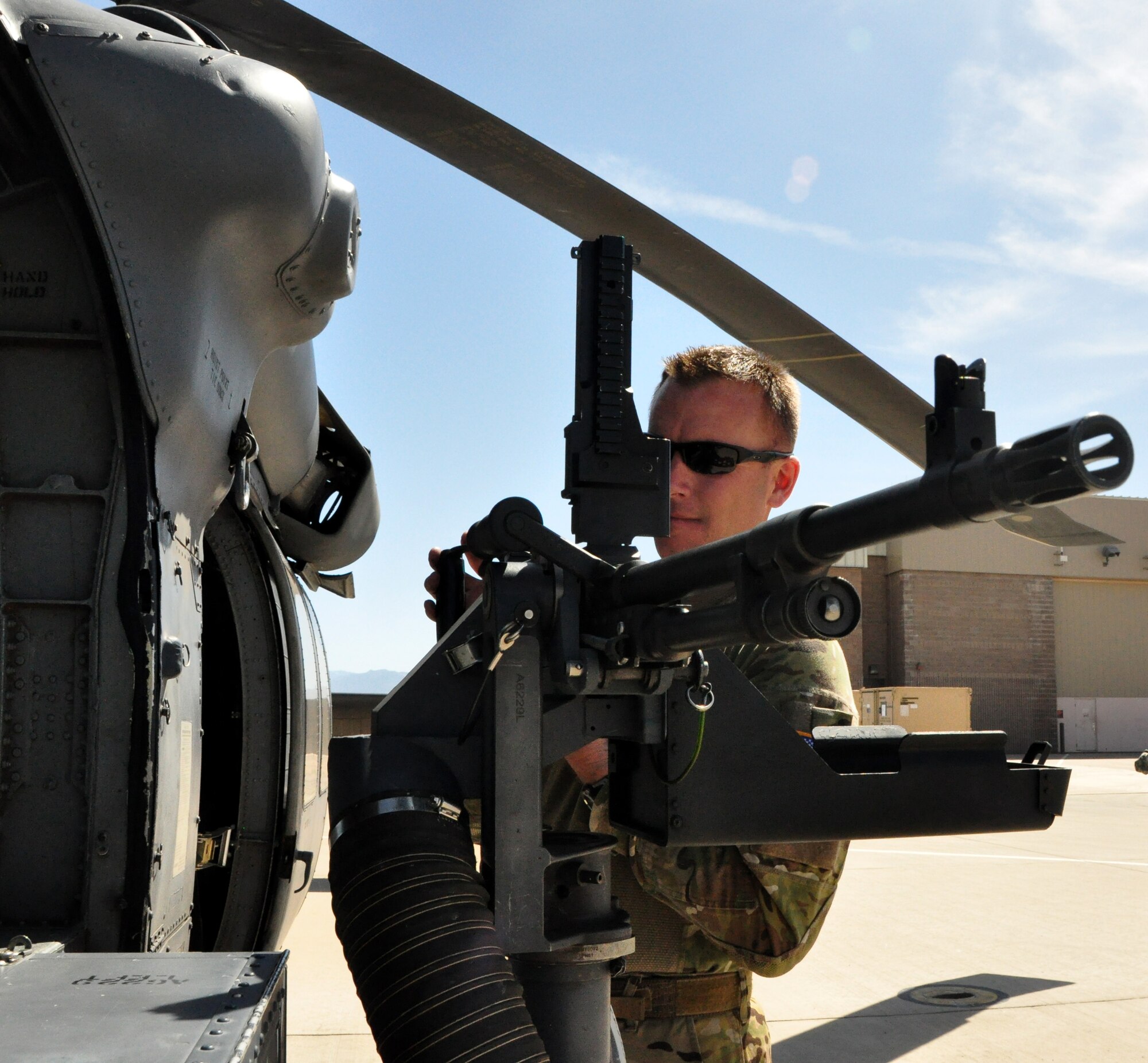 Master Sgt. Daniel Juen, from the 305th Rescue Squadron, completes an operational weapons check prior to a training flight on the HH-60G Pave Hawk helicopter during the 943rd Rescue Group’s April Unit Training Assembly weekend on Davis-Monthan Air Force Base, Tucson Ariz. (U.S. Air Force Photo/Staff Sgt. Sarah Pullen)