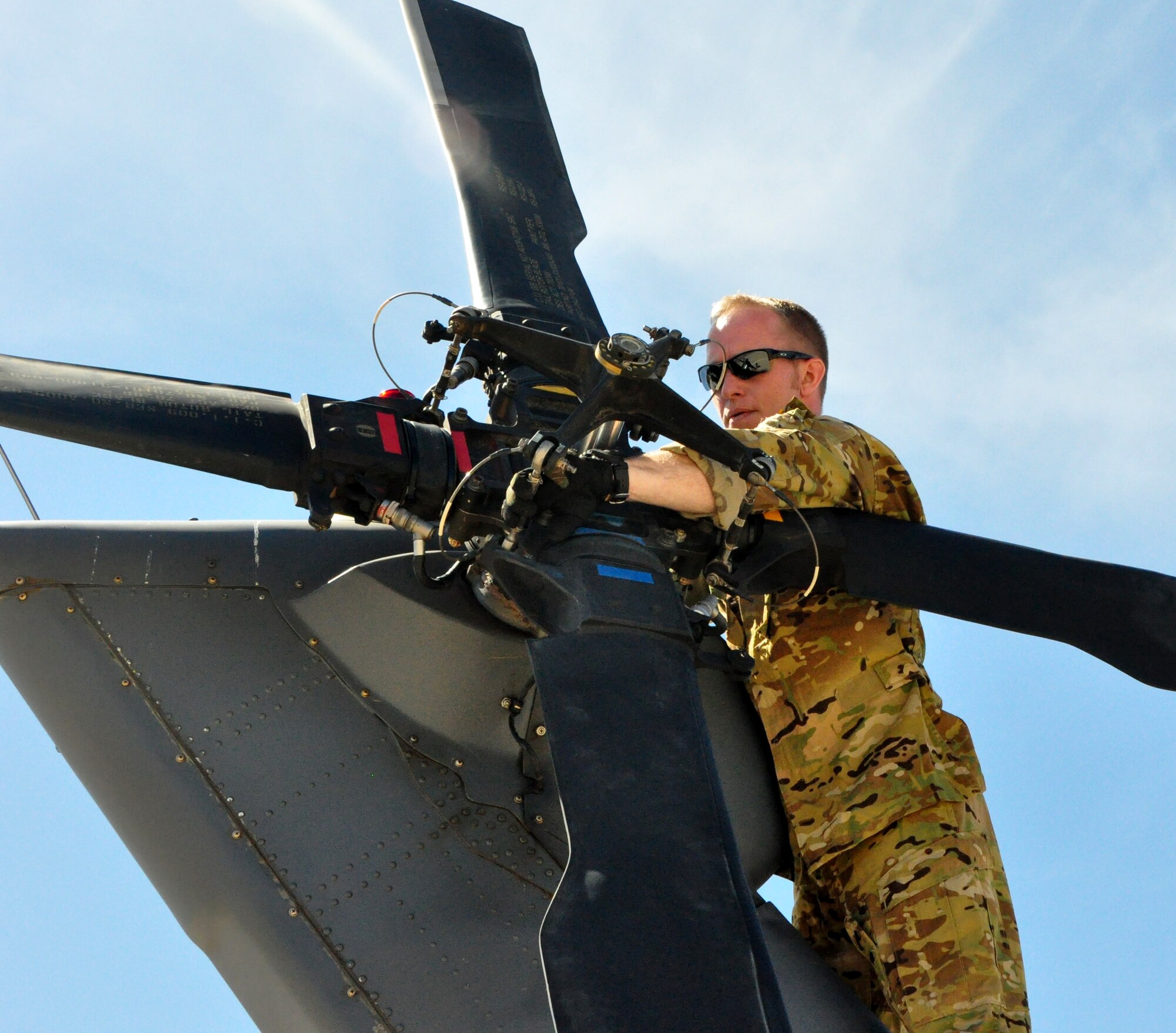 Tech Sgt. Sean Loose, with the 305th Rescue Squadron, completes preflight check on the HH-60G Pave Hawk helicopter prior to a routine training flight during the 943rd Rescue Group’s April Unit Training Assembly weekend at Davis-Monthan Air Force Base, Tucson Ariz. (U.S. Air Force Photo/Staff Sgt. Sarah Pullen)