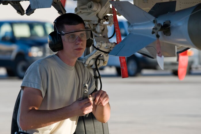 Senior Airman Armin Eusebio, 57th Aircraft Maintenance Squadron aircraft armament systems technician, checks a technical order log during a quarterly load crew competition April 5, 2013, at Nellis Air Force Base, Nev.  Load crew members are selected to participate in the competition by their section chiefs based on overall job performance. (U.S. Air Force Photo by Airman 1st Class Jason Couillard)