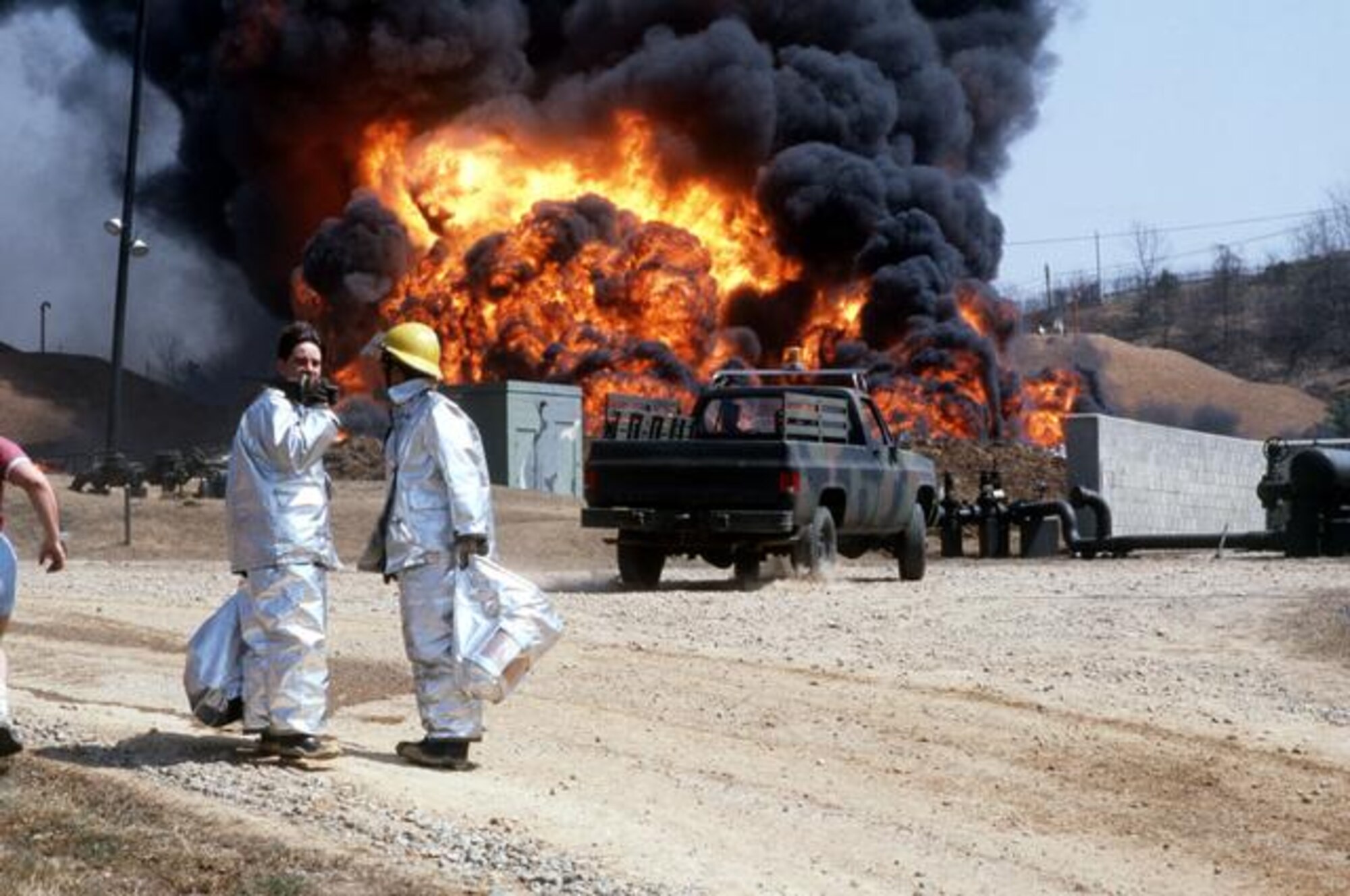 Firefighters with the 51st Civil Engineer Squadron battle a fuel fire after an explosion on Hill 170 at Osan Air Base, Republic of Korea April 5, 1986. It took teams almost 18 hours to put the fire out. (Courtesy photo)