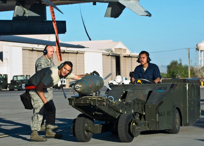 Staff Sgt. Michael Briston and Senior Airman Constantine Bolo, 57th Aircraft Maintenance Squadron armament systems technicians, prepare to load a guided bomb unit during a quarterly load crew competition April 5, 2013, at Nellis Air Force Base, Nev.  Weapons load competitions are conducted quarterly to keep Airmen sharp and recognize superior performers. (U.S. Air Force Photo by Airman 1st Class Jason Couillard)