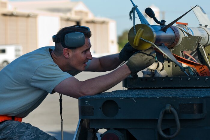 Staff Sgt. Michael Briston, 57th Aircraft Maintenance Squadron aircraft armament systems technician, prepares to upload an AIM-9 Sidewinder during a quarterly load crew competition April 5, 2013, at Nellis Air Force Base, Nev. The competitions give the separate aircraft maintenance units the opportunity to display their skills to the 57th Wing commander. (U.S. Air Force Photo by Airman 1st Class Jason Couillard)