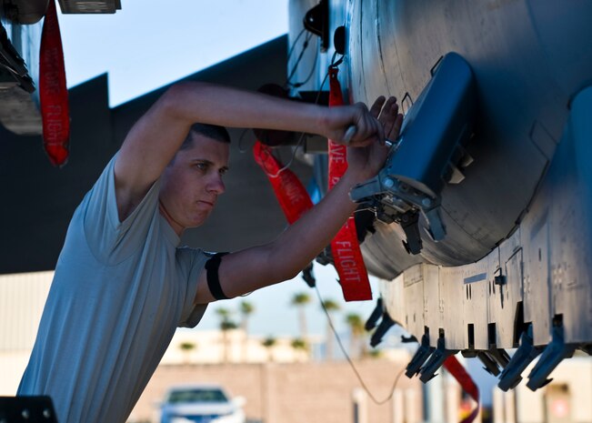 Staff Sgt. Darren Kressin, 57th Aircraft Maintenance Squadron aircraft armament systems technician, prepares to upload munitions during a quarterly load crew competition April 5, 2013, at Nellis Air Force Base, Nev. Weapons loaders have many duties that include loading, unloading, positioning, and preparing munitions. (U.S. Air Force Photo by Airman 1st Class Jason Couillard)