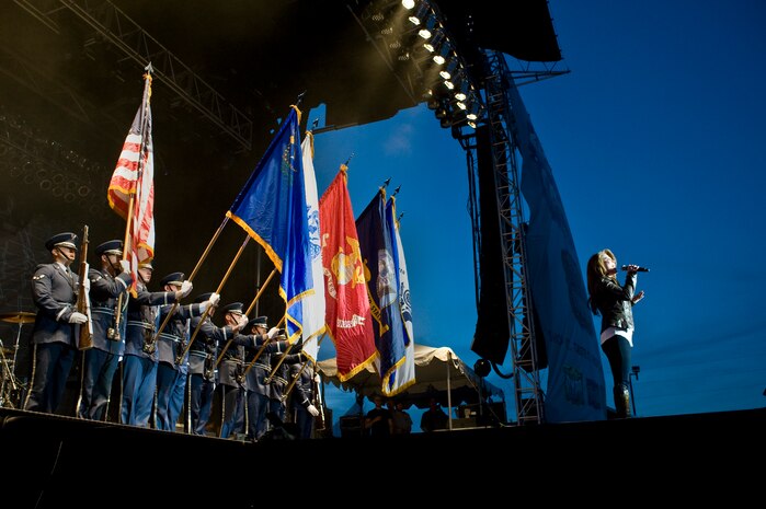 The Nellis Air Force Base Honor Guard presents the colors as Tech. Sgt. Angie Johnson, Missouri Air National Guard, sings the national anthem at the Academy of Country Music Party for a Cause festival April 6, 2013, at the Orleans Hotel and Casino in Las Vegas. The performers included Dustin Lynch, Love and Theft, Kix Brooks, Lee Brice, Hunter Hayes, Eli Young Band and Dierks Bentley. (U.S. Air Force Photo by Airman 1st Class Jason Couillard)