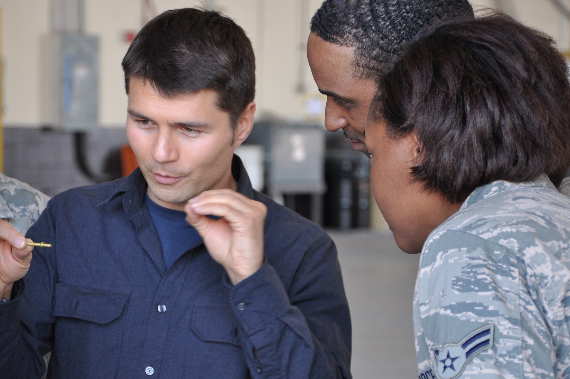 The Travel Channel’s street magician, JB Benn, showing Airmen how to unthread a bolt with their minds on March 29 at Tyndall Air Force Base. He and his crew were filming for their TV show “Magic Man,” which focuses on Mr. Benn stunning the average by stander on the street with his magic.