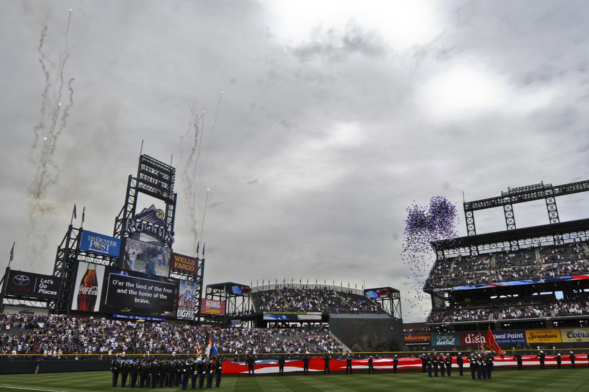The crowd cheers as fireworks explode and balloons are released at the Colorado Rockies Opening Day April 5, 2013, at Coors Field, Denver.  Service members from all U.S. military branches stood in formations as local law enforcement and fire department members unfurled the flag during the opening day ceremonies. (U.S. Air Force photo by Airman 1st Class Riley Johnson/Released)