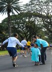 Shari Freeman, Joint Base Pearl Harbor-Hickam Sexual Assault Response Coordinator (Navy), and her son Davis Freeman, 2, encourage runners during the monthly wing fun run at Joint Base Pearl Harbor-Hickam, Hawaii, April 5, 2013. The Sexual Assault Prevention and Response Program reinforces the Department of Defense’s commitment to eliminate incidents of sexual assault through awareness and prevention training, education, victim advocacy, response, reporting and accountability. The Air Force promotes sensitive care and confidential reporting for victims of sexual assault and accountability for those who commit these crimes. (U.S. Air Force photo/Staff Sgt. Terri Paden)