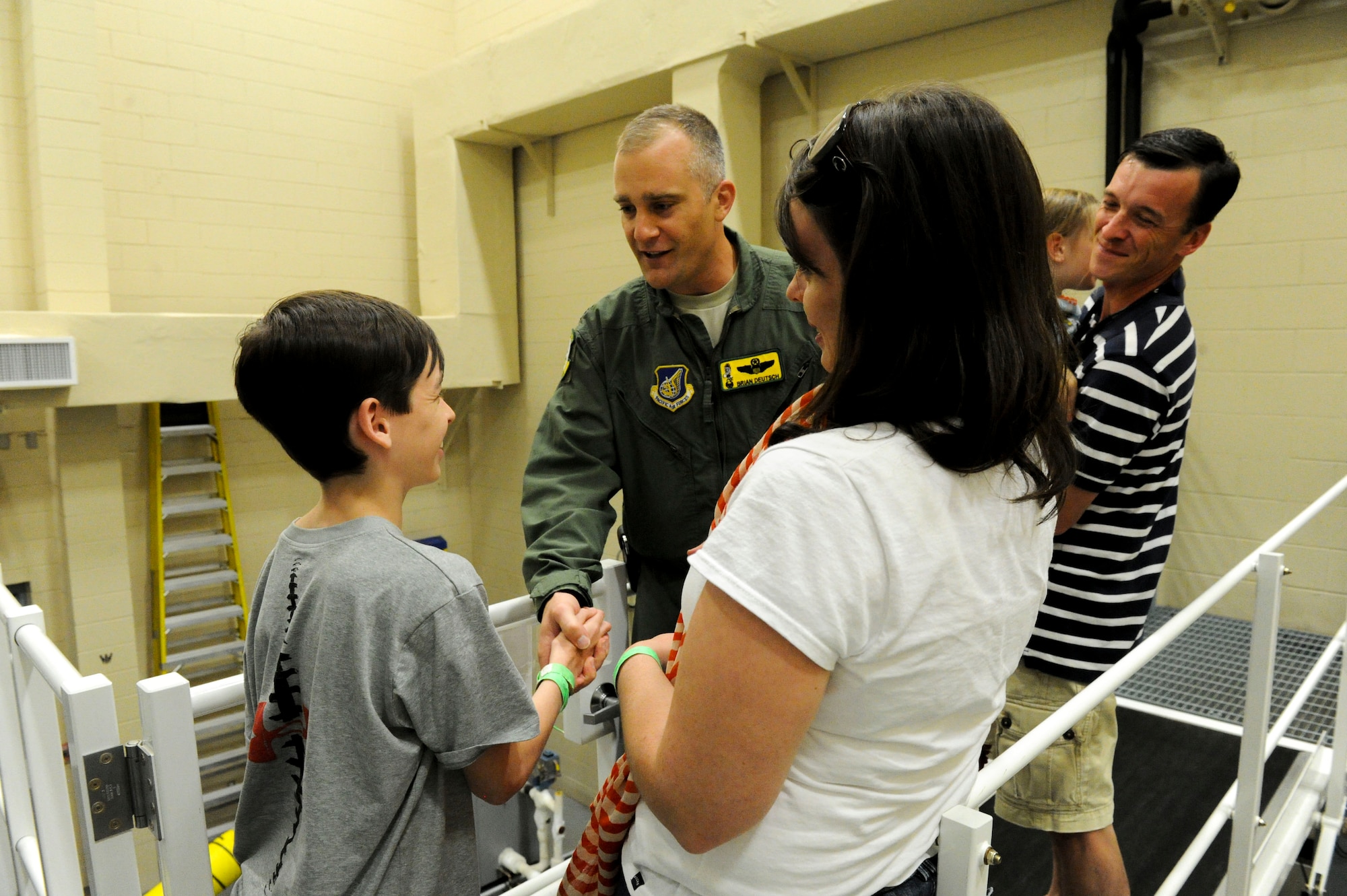 Seth Clifton, who suffers from an acute case of juvenile scleroderma, receives a coin from Lt. Col. Brian Deutsch, 96th Air Refueling Squadron commander, after his KC-135 simulator flight at Joint Base Pearl Harbor-Hickam, Hawaii, March 29, 2013. Clifton, who was visiting Hawaii as part of his “wish” fulfillment from the Make-a-Wish Foundation, was accompanied by his mother and father, April and Brian Clifton, and his siblings, C.J., Noah and Mary Kate. In addition to the visit to the 96 ARS, the family spent the week-long vacation to Hawaii touring the island and visiting with the marine life. (U.S. Air Force photo/Staff Sgt. Terri Paden)