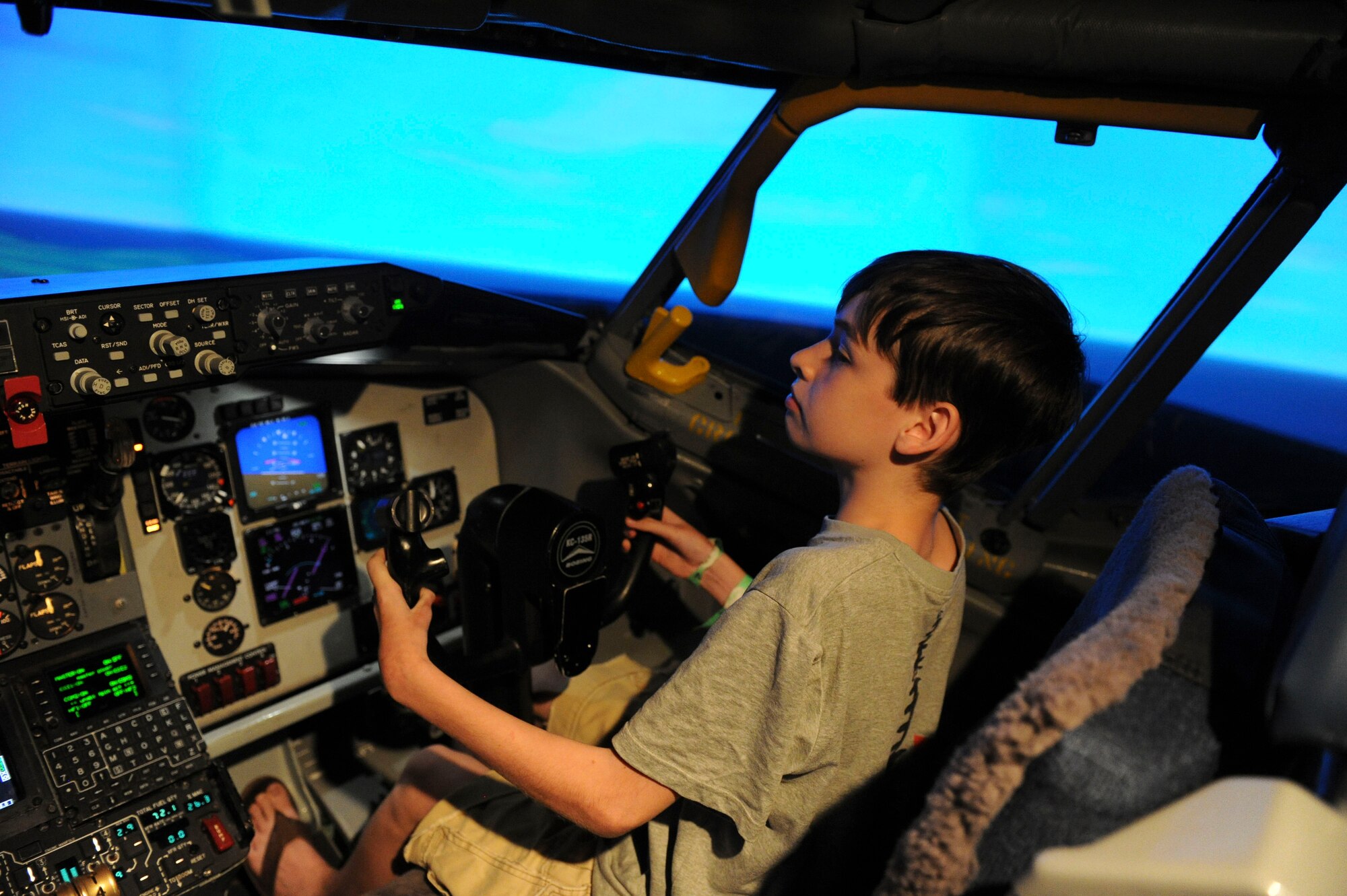 Seth Clifton, who suffers from an acute case of juvenile scleroderma, operates the KC-135 flight simulator during his visit to Joint Base Pearl Harbor-Hickam, Hawaii, March 29, 2013. Clifton was offered the opportunity to try the flight simulator by the 96th Air Refueling Squadron and Chaplian Lt. Col Dave Terrinoni, 15th Wing deputy command chaplain, after it was discovered he would be visiting Hawaii as part of his “wish” fulfillment from the Make-a-Wish Foundation. (U.S. Air Force photo/Staff Sgt. Terri Paden)