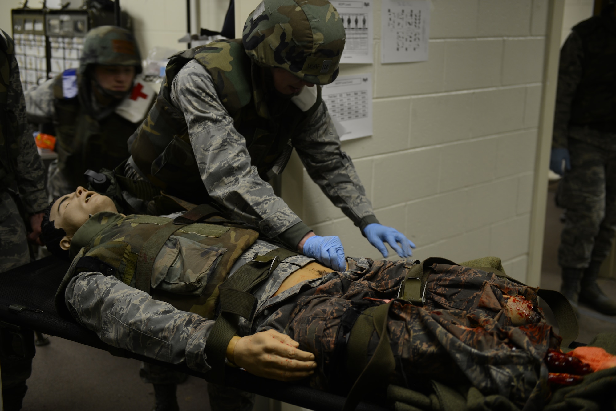 JOINT BASE ELMENDORF-RICHARDSON, Alaska – Members of the 673d and 176th Medical Group treat a combat casualty in response to a simulated triage medical scenario at the Expeditionary Medical Support area, April 7. Phase II of the Polar Force exercise simulates deployment scenarios to familiarize service members on proper operating procedures. (U.S. Air Force photo/Airman Ty-Rico Lea)