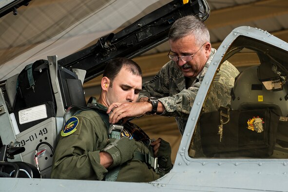 U.S. Air Force Capt. Taylor Petty gets strapped in by Tech. Sgt. Robert Berg prior to a sortie, April 8, 2013, Barksdale Air Force Base, La. This sortie marks the last time Berg will strap a pilot into his aircraft, an A-10 Thunderbolt II, since it is among the first three aircraft selected to leave Barksdale in preparation of the inactivation of the 917th Fighter Group. (U.S. Air Force photo by Master Sgt. Greg Steele/Released)